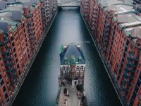 The Wasserschloss in the middle of a canal between the row of historic warehouses in Speicherstadt