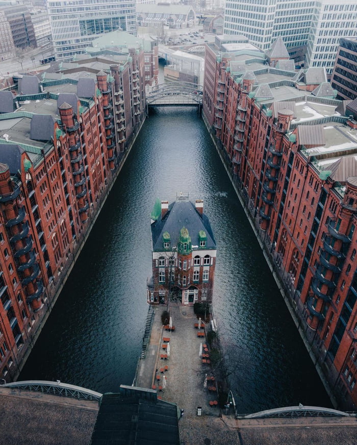 The Wasserschloss in the middle of a canal between the row of historic warehouses in Speicherstadt